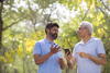 a man talking animatedly with an older man outdoors